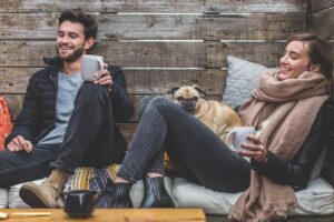 couple relaxing with a pet at a house sit