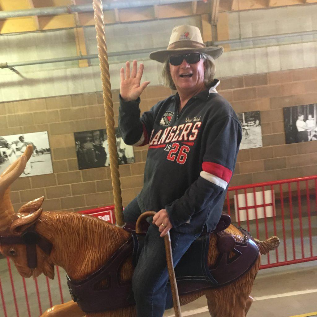 man riding the carousel